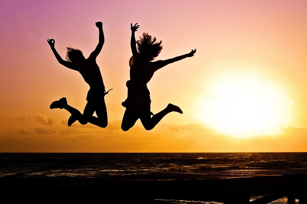 new year background, sunset, beach, silhouettes, jump, jumping, youth, active, happy, pair, girls, young women, people, joy, nature, freedom, seaside, dusk